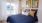a bed with a blue and white comforter