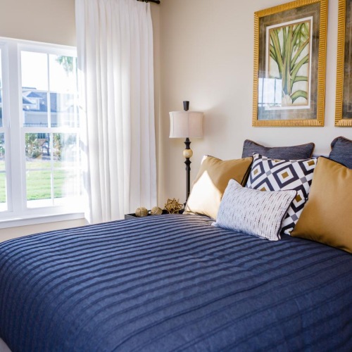 a bed with a blue and white comforter