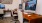 a desk with a computer and chairs