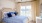 a bedroom with a bed and a fan